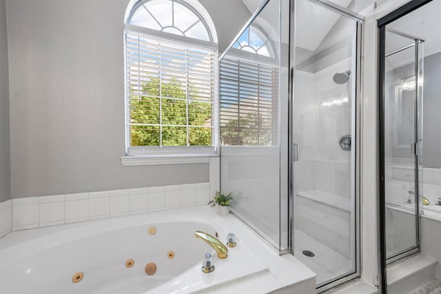 full bathroom with a stall shower and a jetted tub