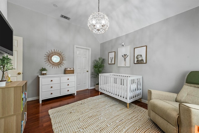 bedroom featuring wood finished floors, a notable chandelier, visible vents, baseboards, and lofted ceiling