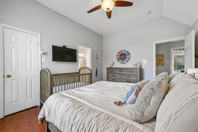 bedroom with a ceiling fan, wood finished floors, and vaulted ceiling