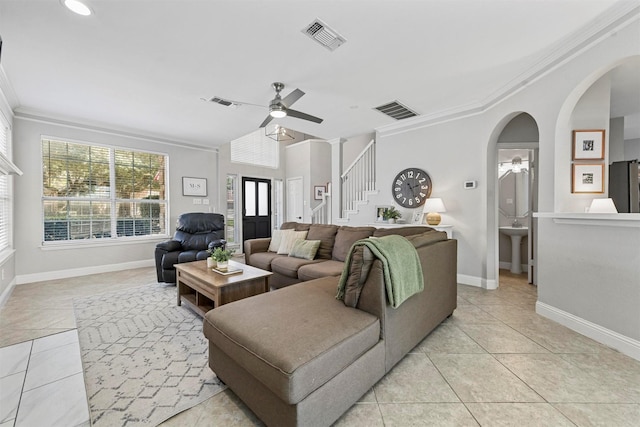 living room with light tile patterned floors, visible vents, and ceiling fan