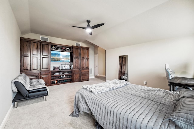 bedroom featuring baseboards, visible vents, light colored carpet, and vaulted ceiling