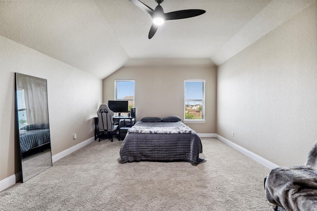 bedroom featuring light carpet, baseboards, lofted ceiling, and ceiling fan