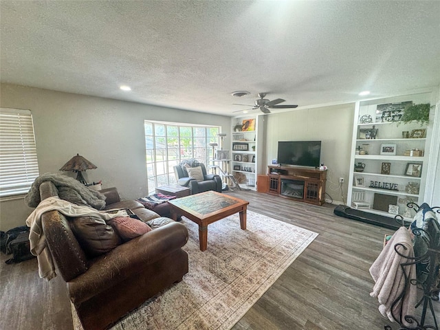 406 Mockingbird Ln, Chico, TX 76431 - living room featuring ceiling fan, a textured ceiling, and wood finished floors
