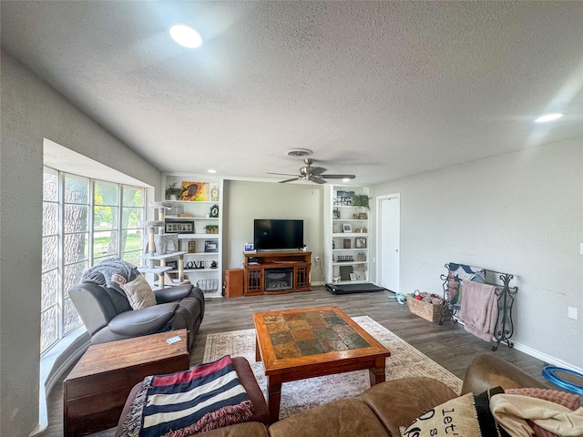 406 Mockingbird Ln, Chico, TX 76431 - living room featuring a textured ceiling, wood finished floors, baseboards, and ceiling fan