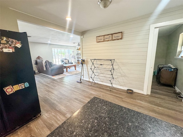 406 Mockingbird Ln, Chico, TX 76431 - interior space featuring baseboards, wood walls, and wood finished floors