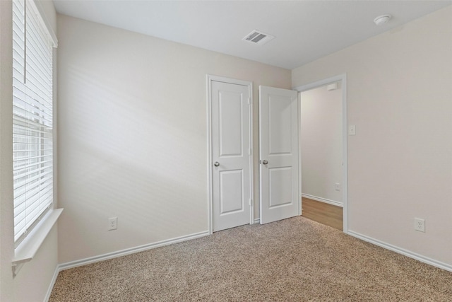 1628 Seadrift Dr, Forney, TX 75126 - unfurnished bedroom featuring carpet and multiple windows