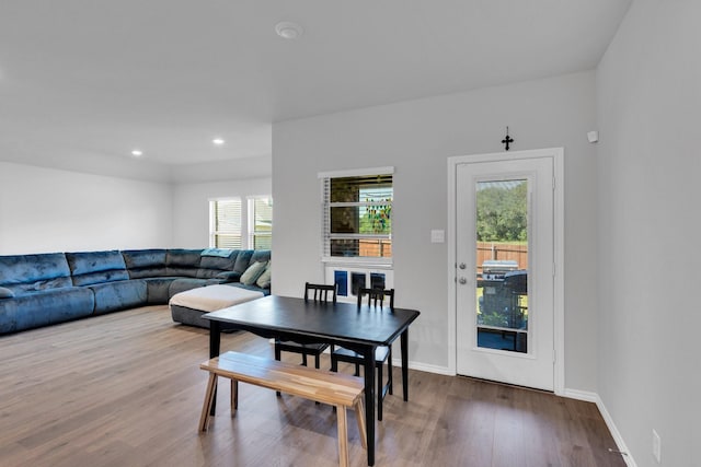 dining room featuring recessed lighting, baseboards, a healthy amount of sunlight, and wood finished floors