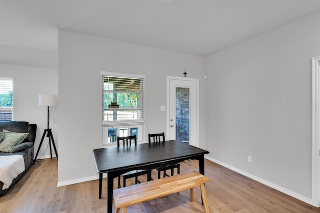 dining room featuring baseboards and light wood finished floors
