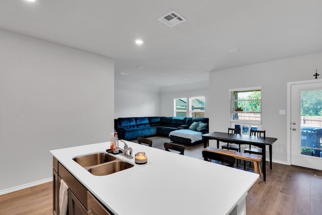 kitchen featuring a sink, visible vents, recessed lighting, light countertops, and light wood-style floors