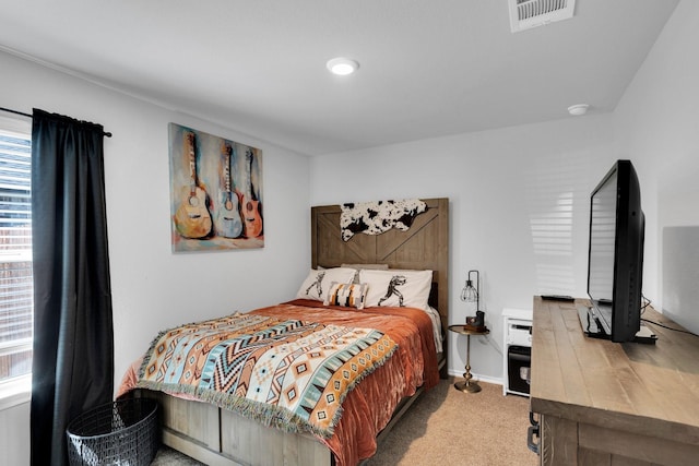 carpeted bedroom with visible vents and baseboards