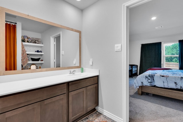 bathroom with ensuite bathroom, baseboards, visible vents, vanity, and recessed lighting