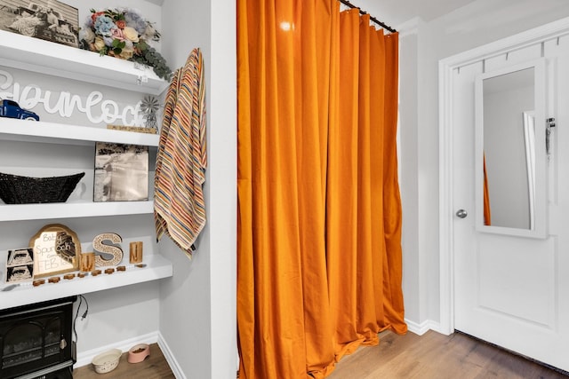 interior space featuring wood finished floors and baseboards