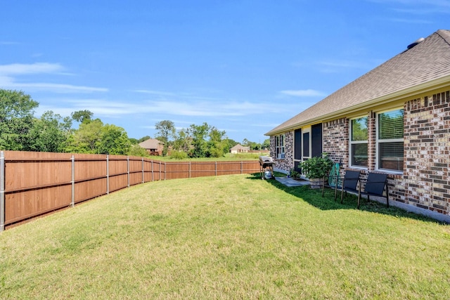 view of yard with a fenced backyard