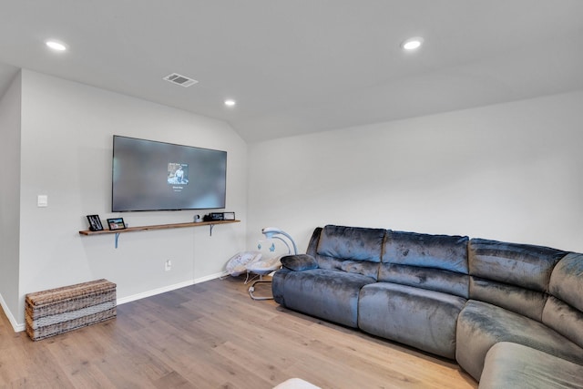 living area featuring wood finished floors, visible vents, baseboards, vaulted ceiling, and recessed lighting