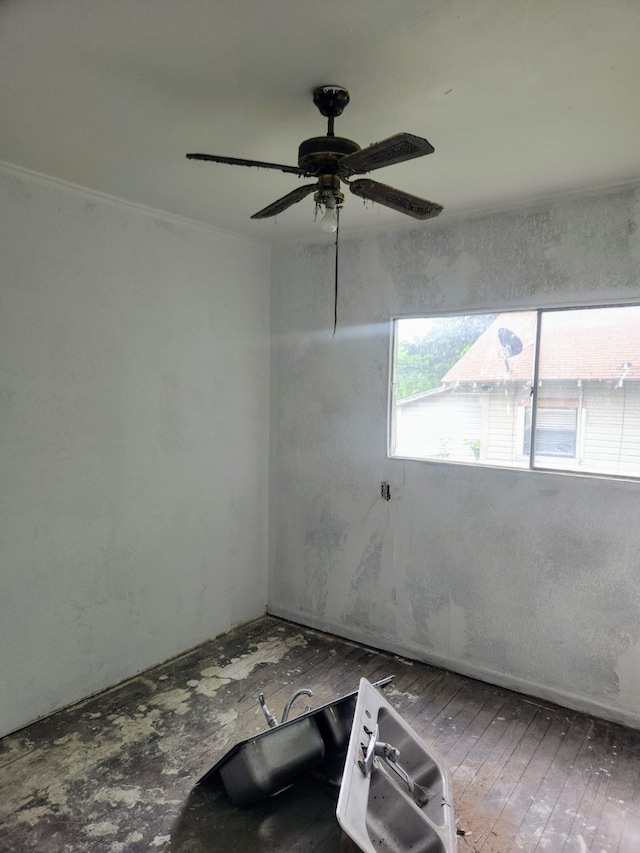 spare room featuring hardwood / wood-style floors and ceiling fan