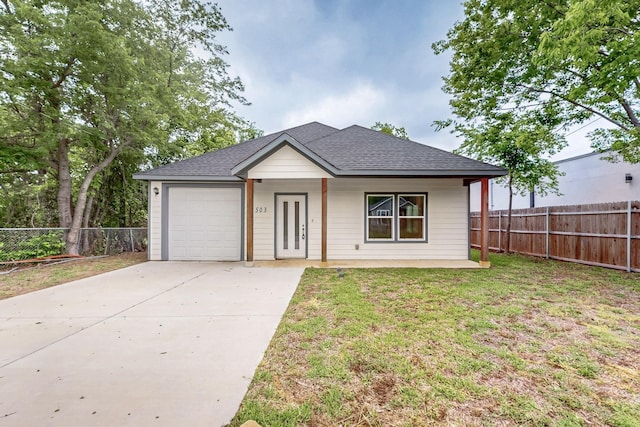 503 W Martin Luther King St, Denison, TX 75020 - ranch-style home with a garage, fence, a shingled roof, and driveway