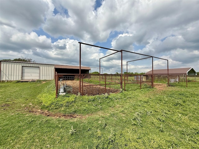 view of yard with an outbuilding, an outdoor structure, and fence