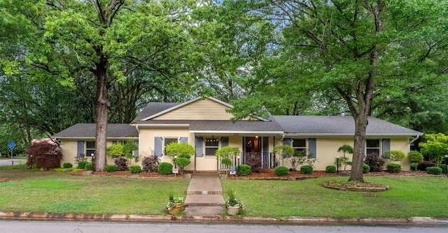 single story home with a porch and a front lawn
