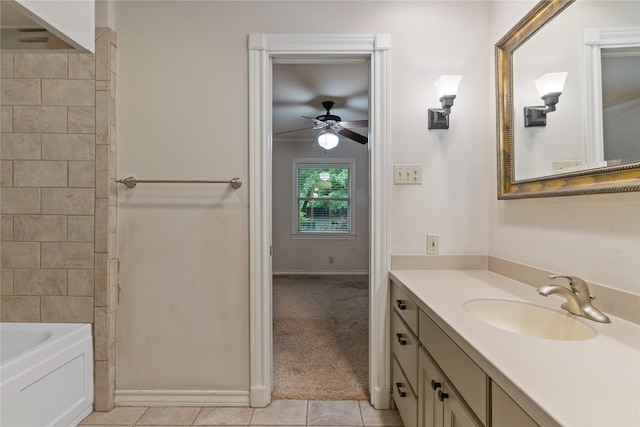 full bathroom featuring a bathtub, vanity, tile patterned floors, ceiling fan, and baseboards