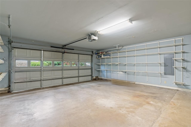 garage featuring electric panel and a garage door opener
