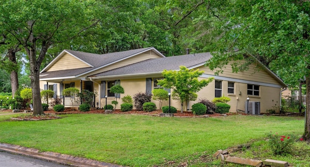 single story home featuring a front yard, roof with shingles, and covered porch