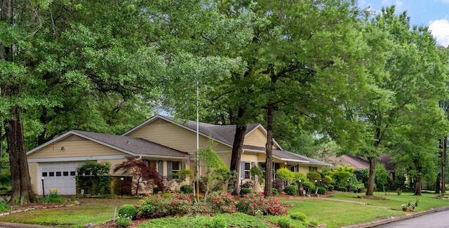single story home featuring a front lawn and an attached garage