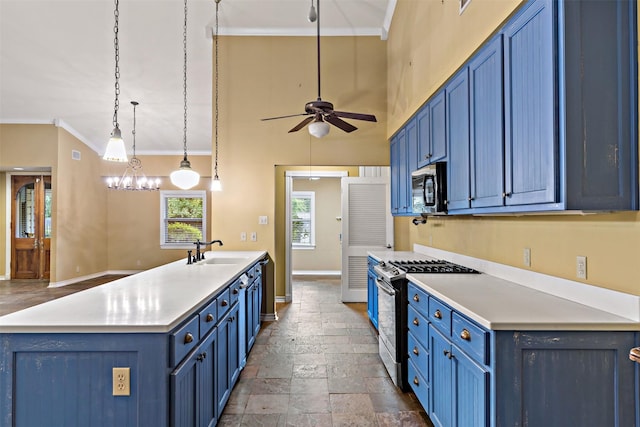 kitchen featuring a peninsula, stainless steel appliances, blue cabinetry, and a sink