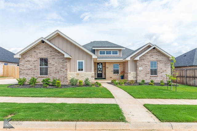 3342 Torrey Pne, Abilene, TX 79606 - craftsman-style house featuring fence, stone siding, a front yard, roof with shingles, and board and batten siding