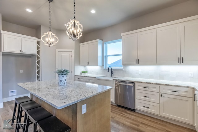 3342 Torrey Pne, Abilene, TX 79606 - kitchen featuring a center island, stainless steel dishwasher, a sink, a chandelier, and backsplash