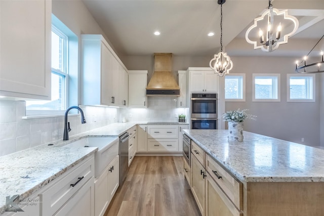 3342 Torrey Pne, Abilene, TX 79606 - kitchen featuring an inviting chandelier, light stone countertops, appliances with stainless steel finishes, a kitchen island, and custom exhaust hood