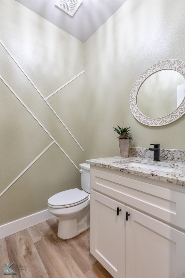 3342 Torrey Pne, Abilene, TX 79606 - bathroom with vanity, toilet, visible vents, and wood finished floors