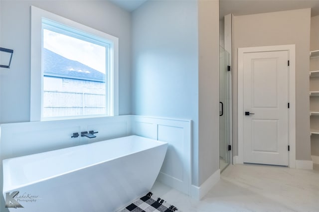 3342 Torrey Pne, Abilene, TX 79606 - full bath with a stall shower, a walk in closet, marble finish floor, and a freestanding tub