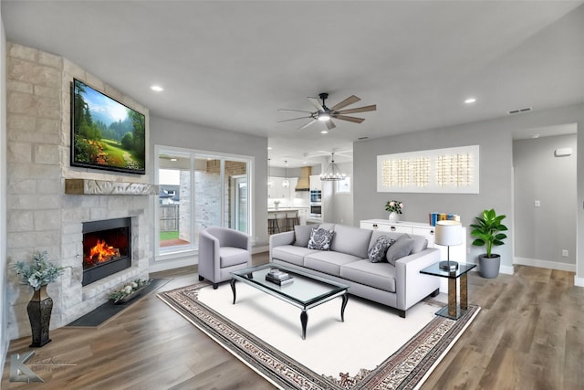 3342 Torrey Pne, Abilene, TX 79606 - living area with a stone fireplace, a ceiling fan, visible vents, and wood finished floors