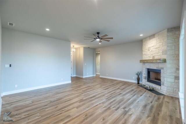 3342 Torrey Pne, Abilene, TX 79606 - unfurnished living room featuring wood finished floors, a ceiling fan, a fireplace, visible vents, and baseboards
