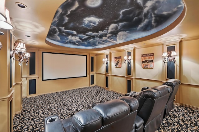 carpeted home theater room featuring a decorative wall, crown molding, and ornate columns