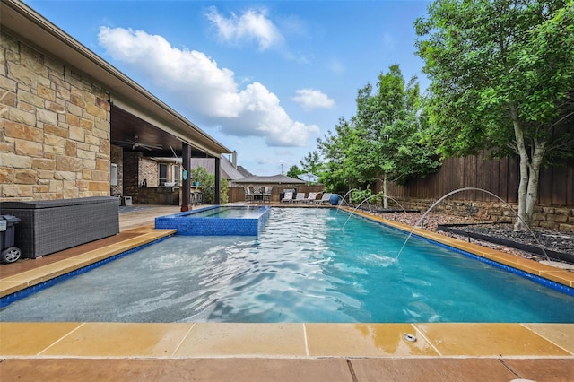 view of pool featuring a jacuzzi, a fenced backyard, ceiling fan, a patio area, and a fenced in pool