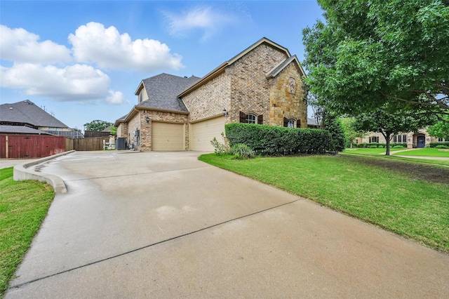 view of home's exterior featuring an attached garage, a yard, fence, concrete driveway, and brick siding