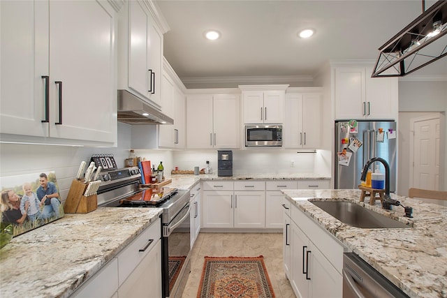 kitchen with a sink, stainless steel appliances, white cabinets, under cabinet range hood, and decorative backsplash