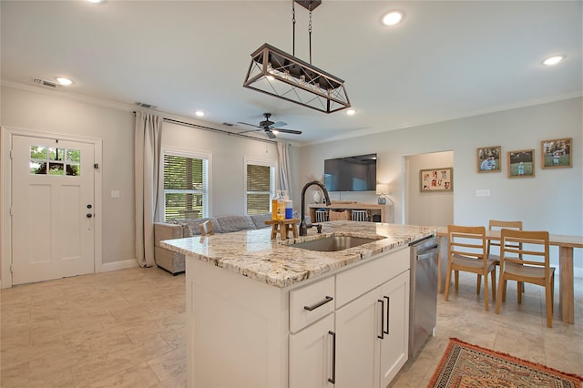 kitchen with a sink, a kitchen island with sink, crown molding, stainless steel dishwasher, and light stone countertops