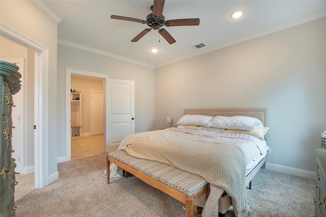 bedroom with baseboards, light carpet, crown molding, and visible vents