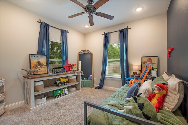 carpeted bedroom featuring recessed lighting, baseboards, and multiple windows