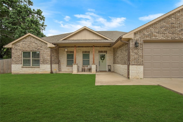exterior space with an attached garage, brick siding, roof with shingles, and a front yard