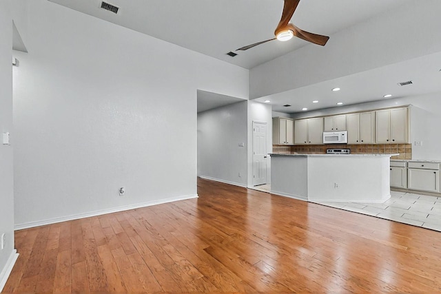 3405 Longneedle Ln, Mckinney, TX 75070 - unfurnished living room with baseboards, ceiling fan, light wood-style flooring, and visible vents
