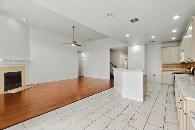 3405 Longneedle Ln, Mckinney, TX 75070 - kitchen featuring a ceiling fan, open floor plan, visible vents, white microwave, and marble finish floor