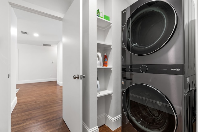 8831 Lanarkshire Dr, Dallas, TX 75238 - washroom with estacked washer and dryer, baseboards, wood finished floors, and built in features