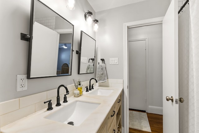 8831 Lanarkshire Dr, Dallas, TX 75238 - bathroom featuring double vanity, wood finished floors, and baseboards