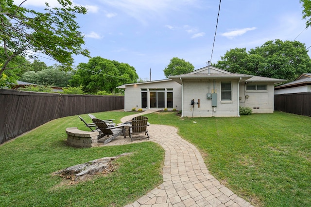 8831 Lanarkshire Dr, Dallas, TX 75238 - rear view of property with brick siding, a patio area, and a fire pit