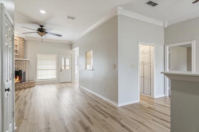 unfurnished living room featuring crown molding, visible vents, and ceiling fan