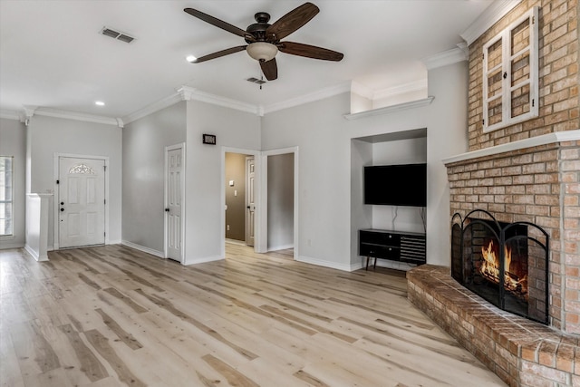 unfurnished living room with crown molding, visible vents, a fireplace, and a ceiling fan