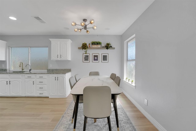 1130 Via Del Rey, Mesquite, TX 75150 - dining area featuring light wood-style floors, visible vents, baseboards, and a notable chandelier